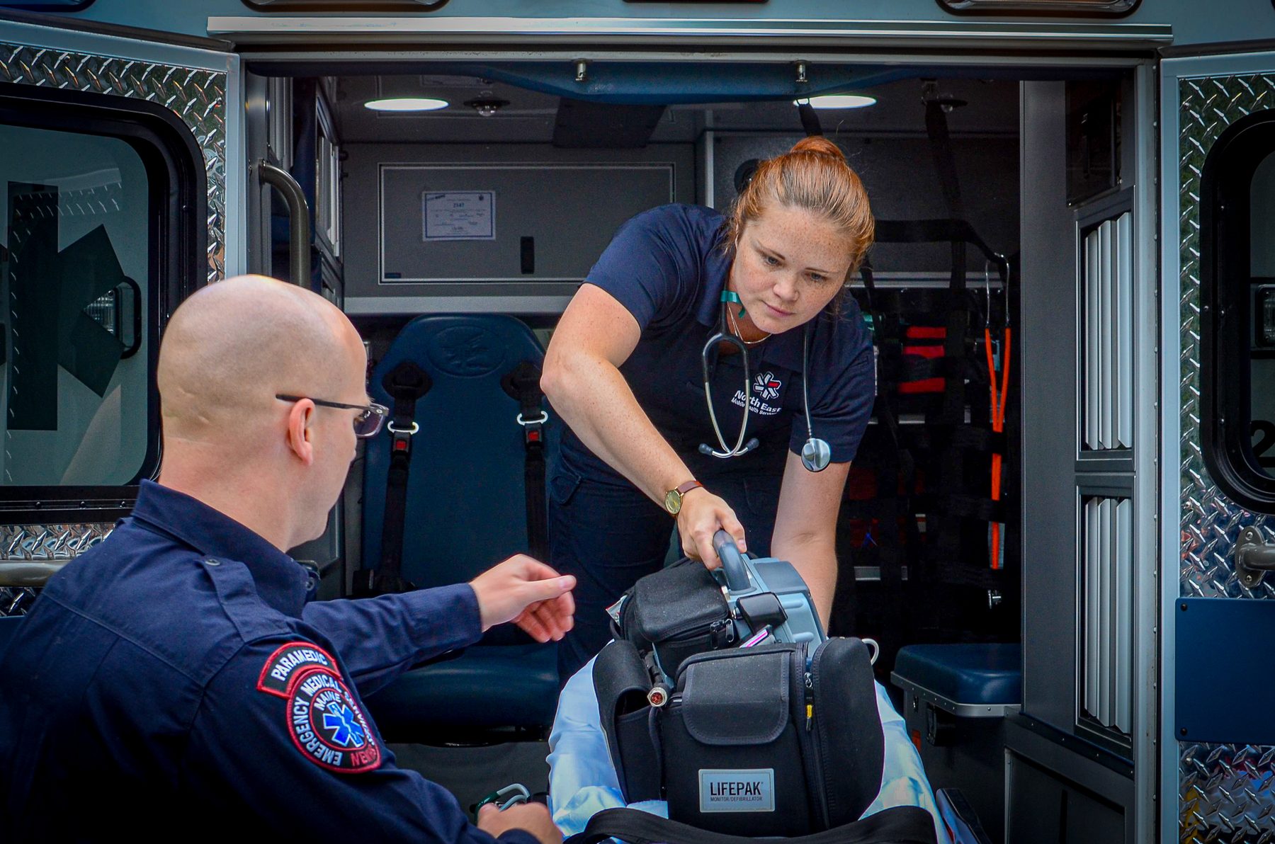 NEMHS crew preparing equipment at the ambulance