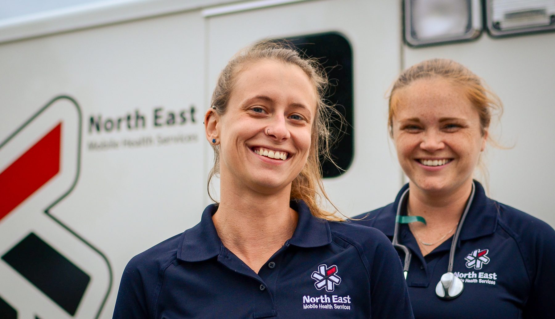 NEMHS paramedics beside an ambulance